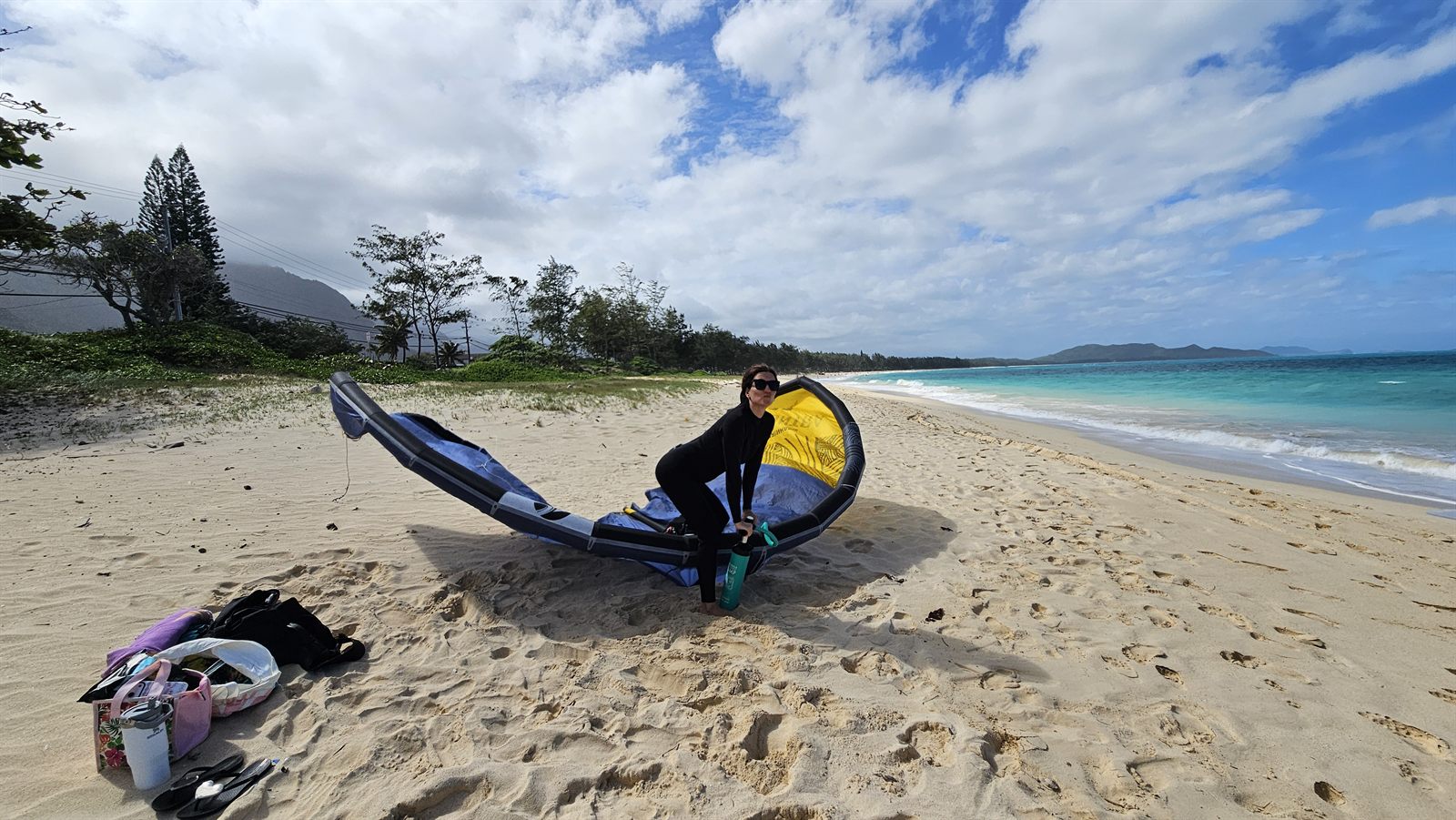 Lidiya on the beach with a kitesurfing kite