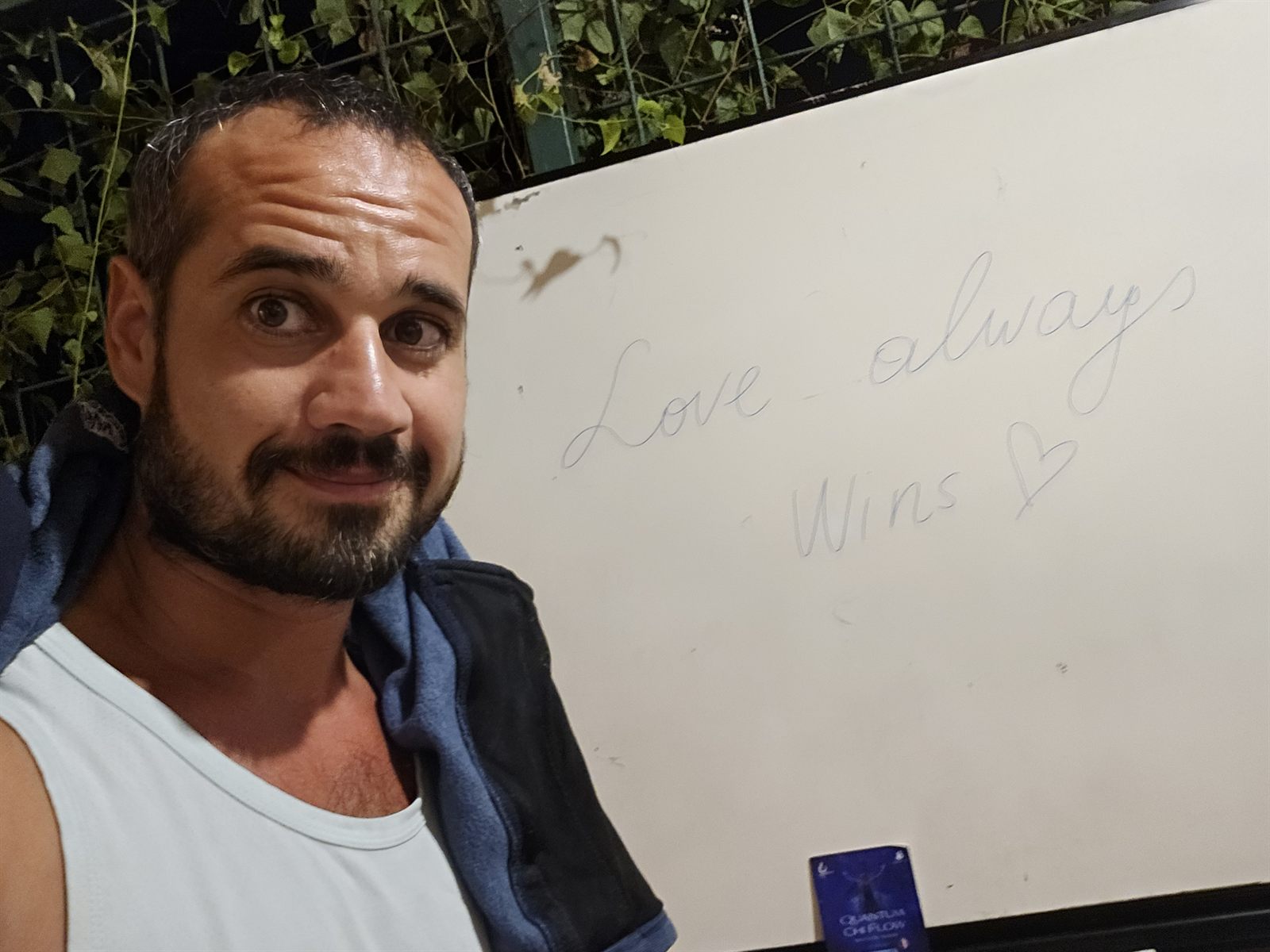 A whiteboard with the handwritten words: Love always Wins