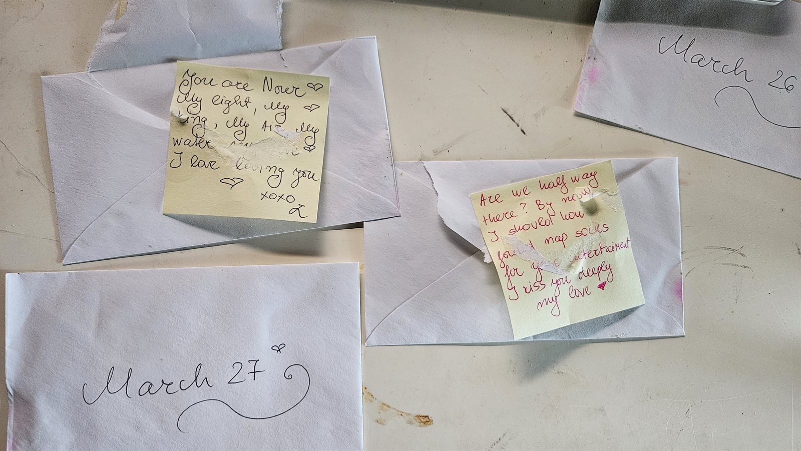 Handwritten love notes tucked into envelopes